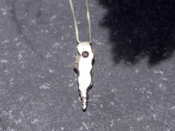 A handmade unique recycled silver pendant with a small pink sapphire. Solid Silv