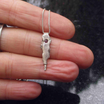 A handmade unique recycled silver pendant with a small pink sapphire. Solid Silv